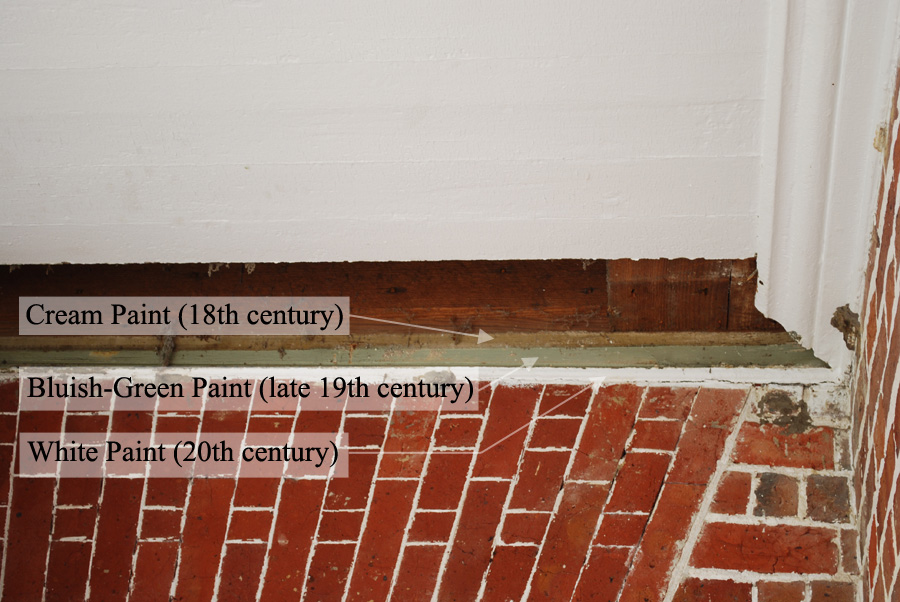 A fascia board has been revealed showing at least three different generations of paint.  The "stacking" of these layers also suggests that the ceiling of the portico was lowered several times.