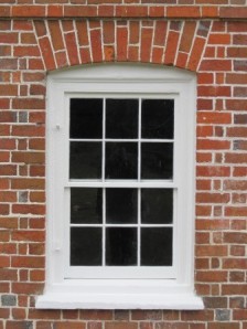 This basement window was repaired by our preservation department in 2013 and shows how the new sashes will look in the other basement window openings. 